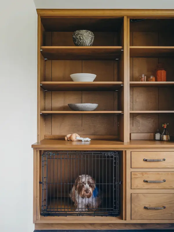 a dog crate built into a cabinet